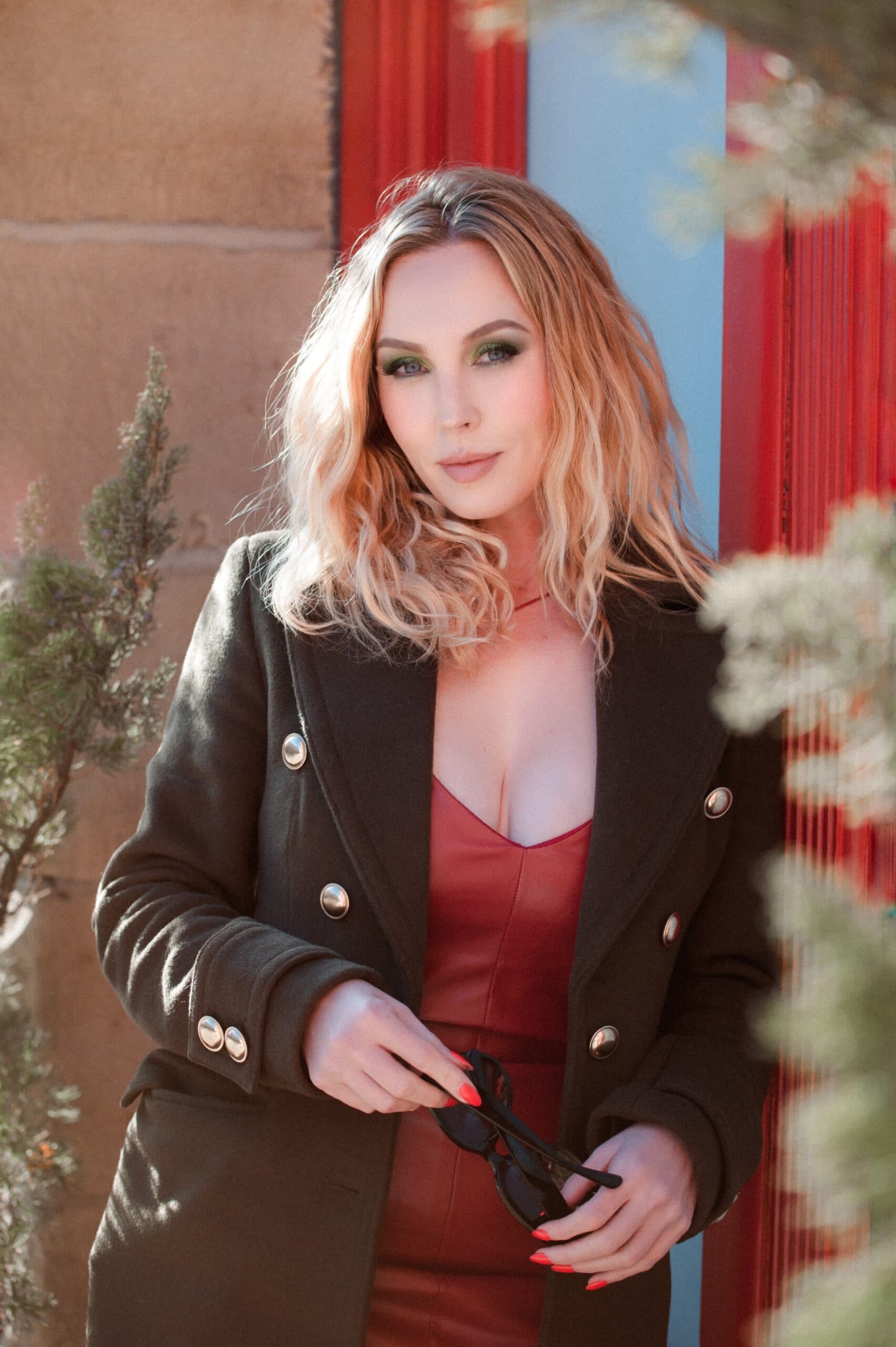 boudoir photographer steff posed in red leather dress and brown leather motorcycle jacket. celebrating yourself.